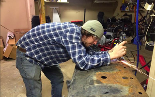 Clay grinds down the bolts on the gas tank skid plate so they won’t hang up on rocks.